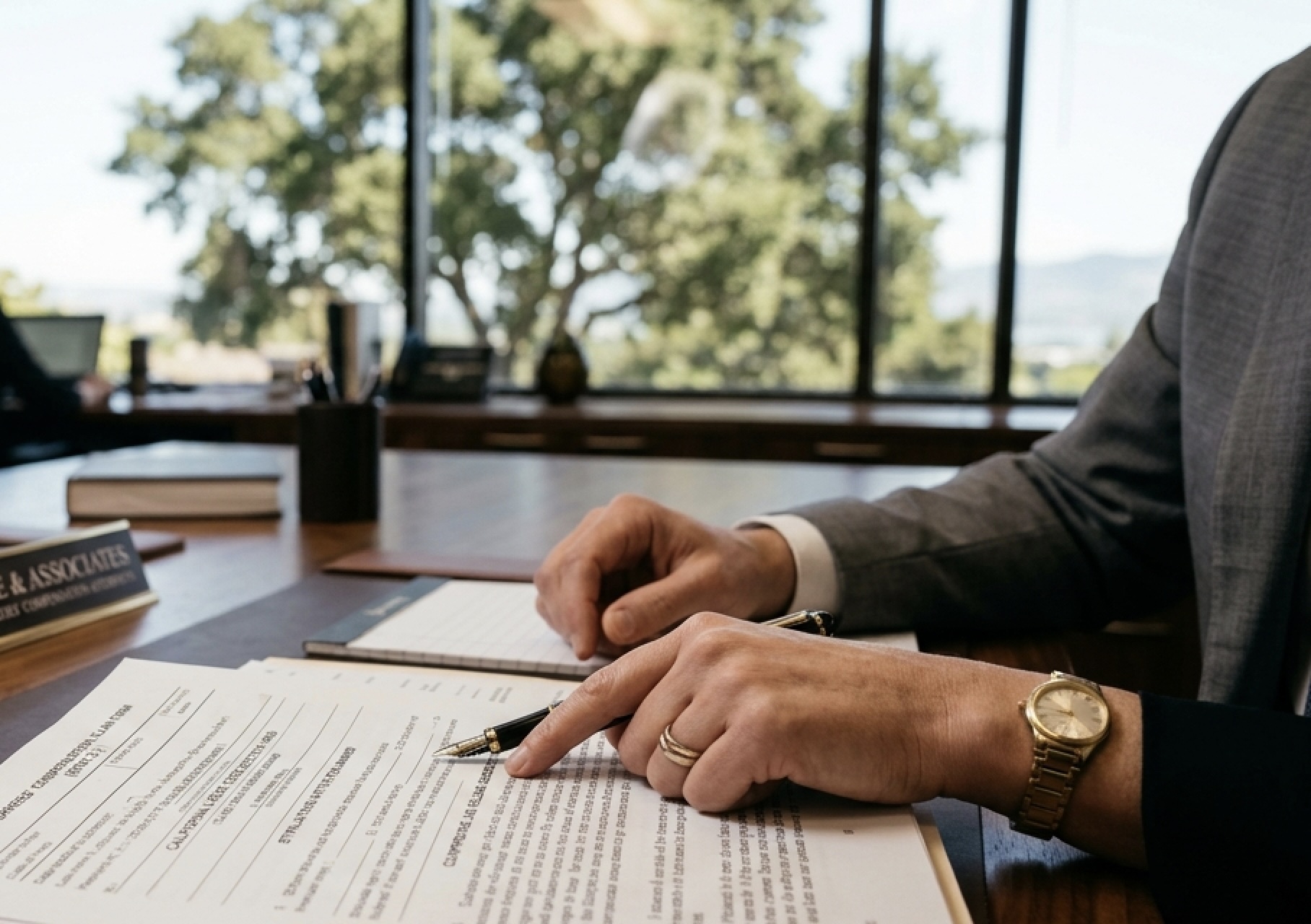 A legal consultation focusing on how to reopen a California workers' comp claim with medical records on a desk.